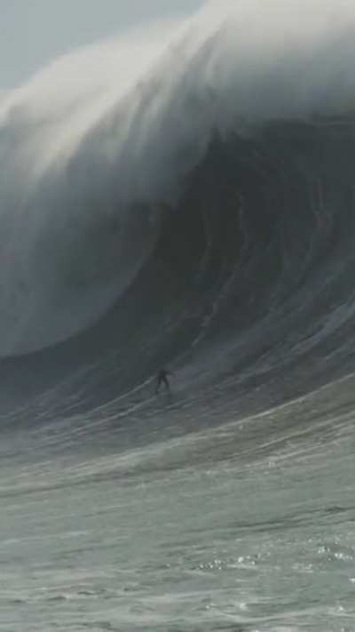 Professional surfer Mason Barnes, riding a wave in Nazare, Portugal