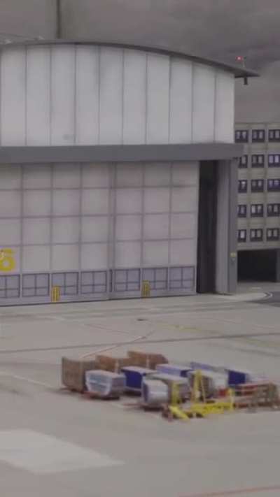 An airppane exiting a service hangar