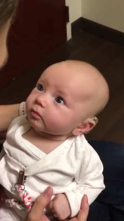 Baby hears mothers voice for the first time with the help of a hearing aid. the reaction is beautiful.