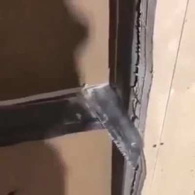 Guy using the saw must be having a hard time