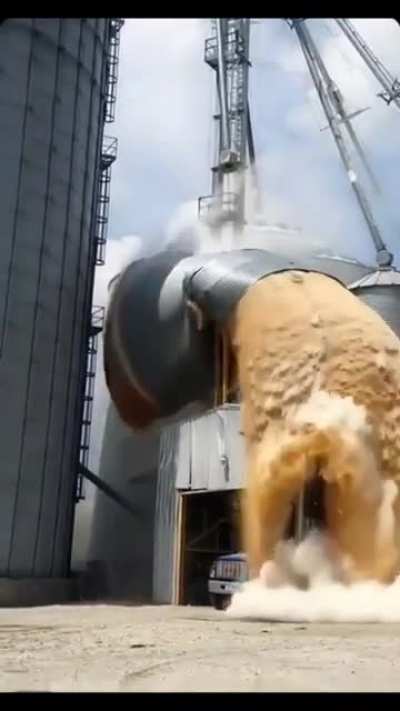 A grain silo dropping to the ground