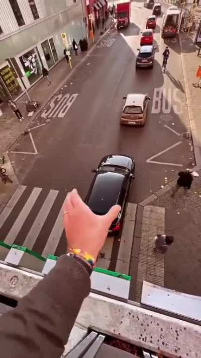 This guy "guiding traffic" from his window