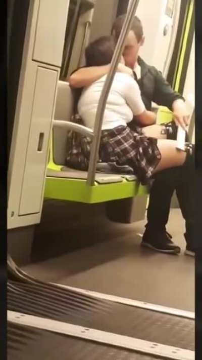 Casually making out in a subway.