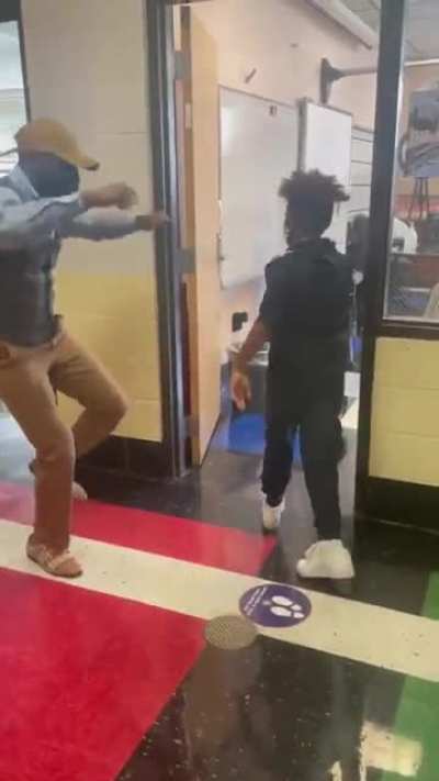 "You don’t have to physically touch a child to actually “touch” a child." - teacher does socially distanced custom greetings to motivate his students